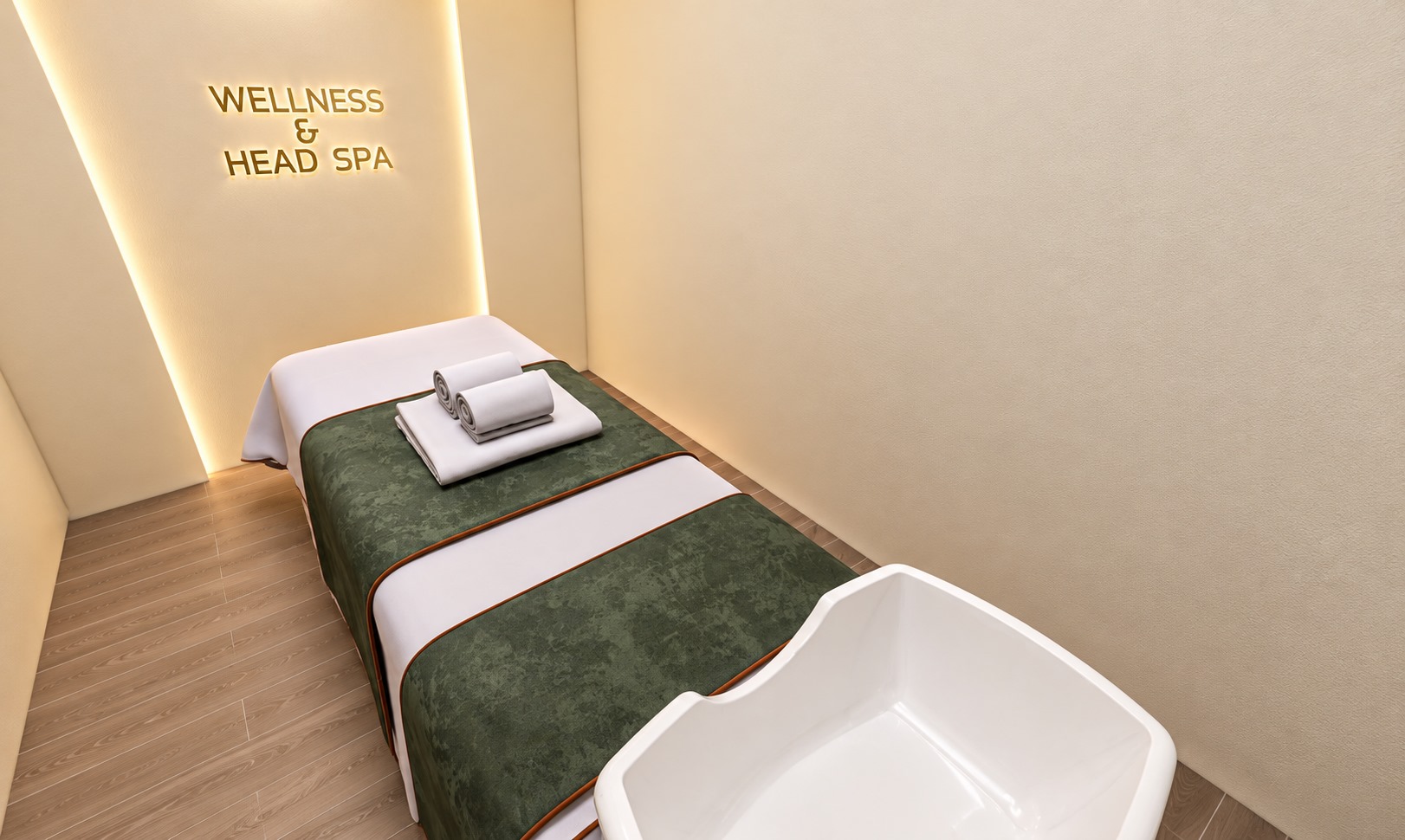 Private head spa suite with green treatment bed